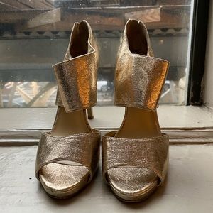 Gold shiny Nine West heels.